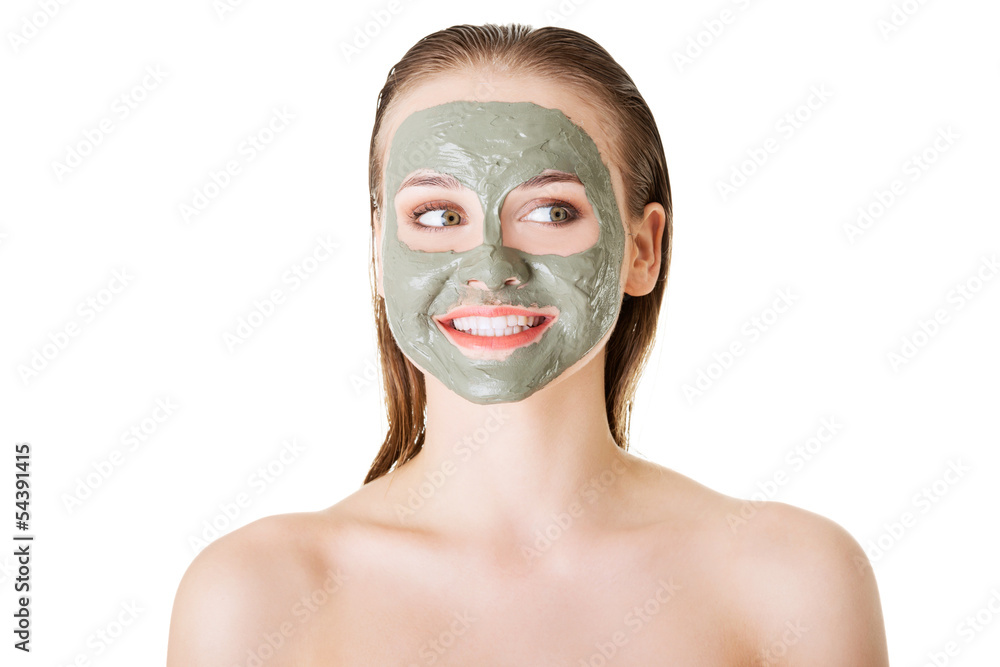 Beautiful woman with clay facial mask, isolated on white Beautiful woman with clay facial mask, isolated on white