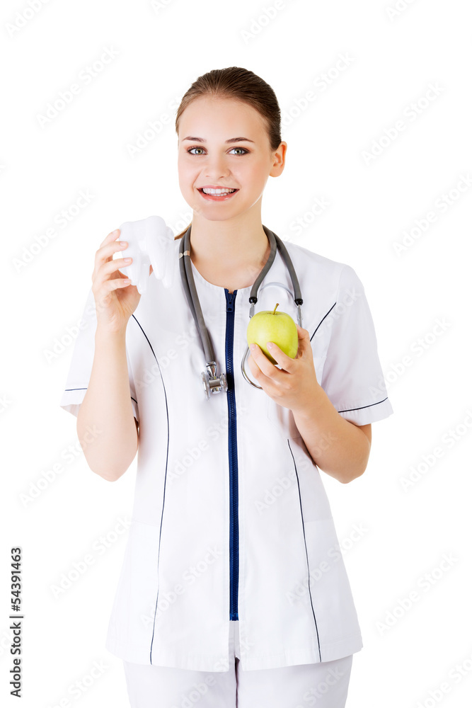 Female dentist with green apple and big tooth Female dentist with green apple and big tooth
