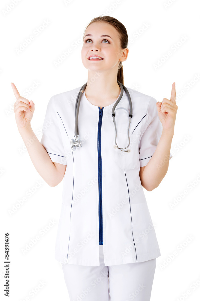 Woman doctor or nurse pointing on copy space. Woman doctor or nurse pointing on copy space.