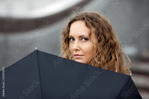 Sad beautiful woman with umbrella