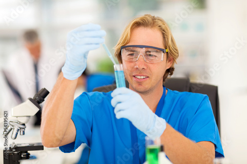 medical researcher working with liquid tubes