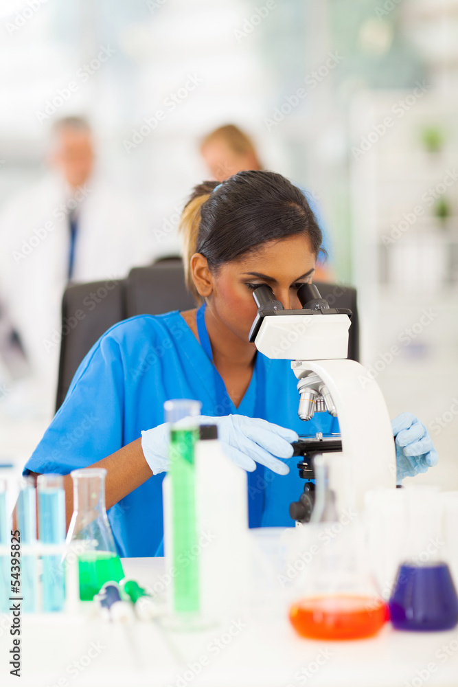 young scientist looking through microscope young scientist looking through microscope