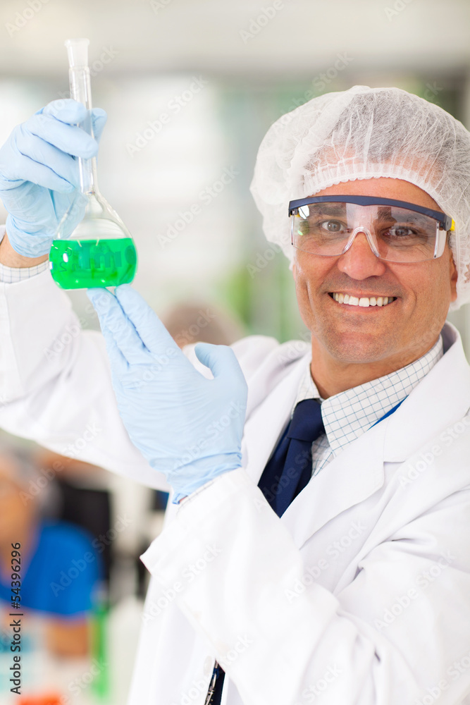 senior medical researcher holding a flask senior medical researcher holding a flask