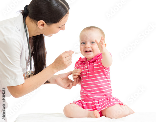 doctor giving medicine to baby girl isolated on white