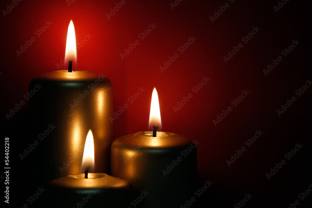 Three burning gold candles