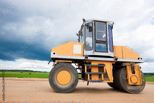 Vibroroller compacting soil during road construction