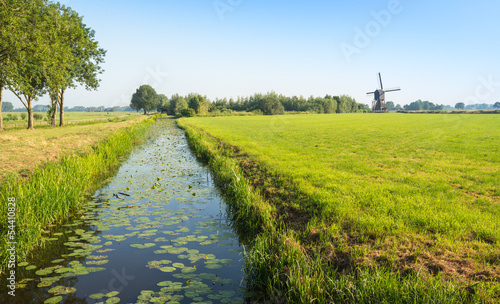 Photo Typical Dutch polder landscape with an old windmill