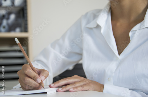 woman writes on letter photo