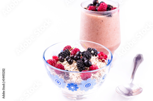 Oat flake porridge with fresh berries isolated