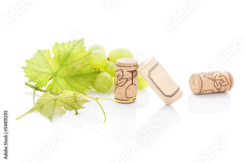 Green grapes and wine corks