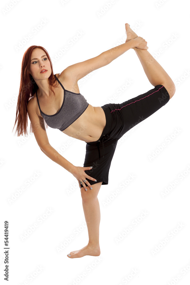 Fototapeta premium Young woman flexes performs yoga stretches.
