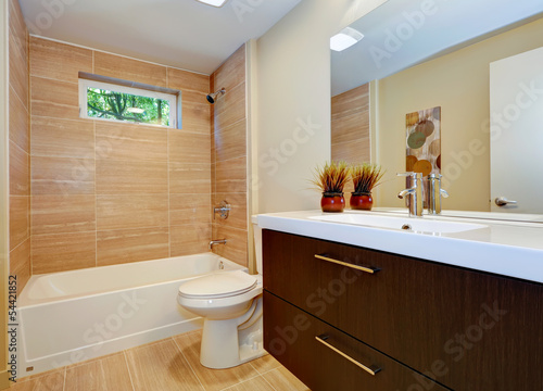 Modern new bathroom design with double sink and white tub.