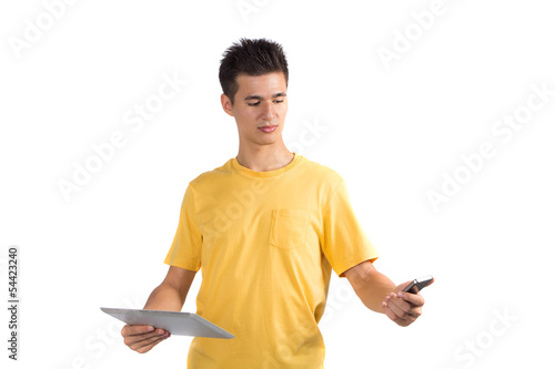 Young man using a mobile phone with tablet computer PC