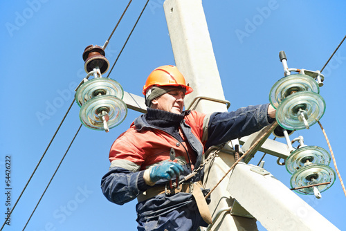 power electrician lineman at work on pole