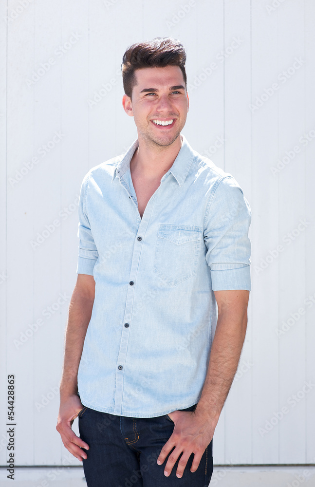 Good looking young man smiling outdoors against white background Good looking young man smiling outdoors against white background