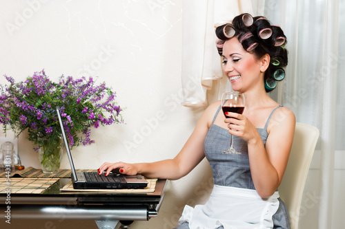 beautiful woman in the kitchen with notebook