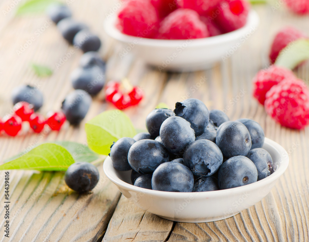 Blueberries and raspberry on wooden table Blueberries and raspberry on wooden table