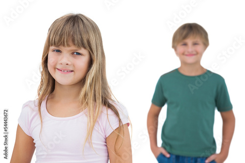 Girl smiling with boy behind her