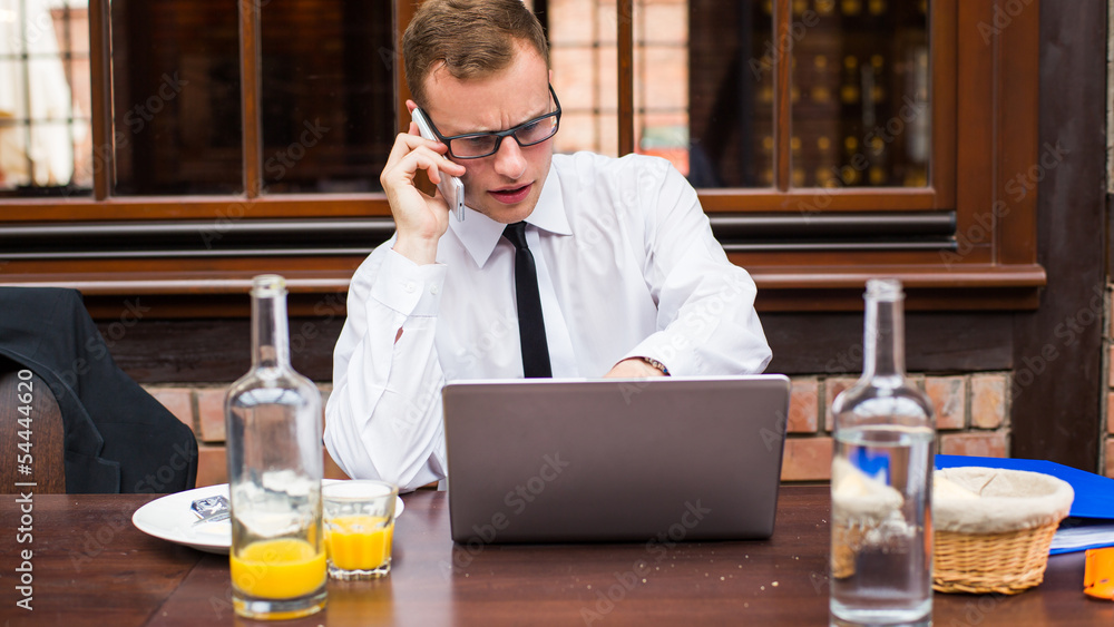 Hard working businessman in restaurant. Close-up. Hard working businessman in restaurant. Close-up.