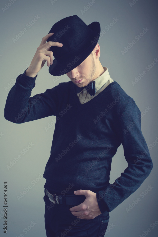 Elegant handsome young man with black hat and bow tie Elegant handsome young man with black hat and bow tie