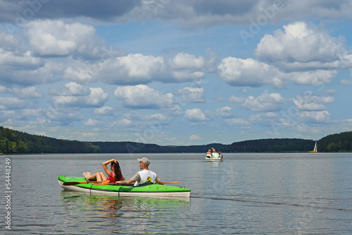 Young couple kayaking summertime  in the sunshine vacation