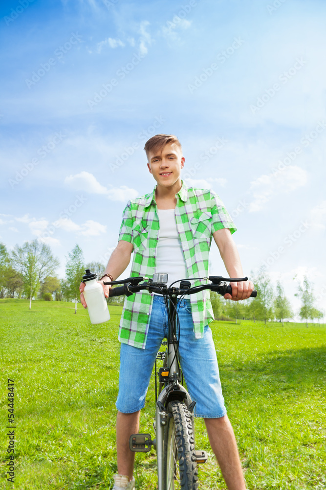 Young biker with bottle of water Young biker with bottle of water
