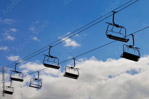 chair lift, cableway on blue sky background photo