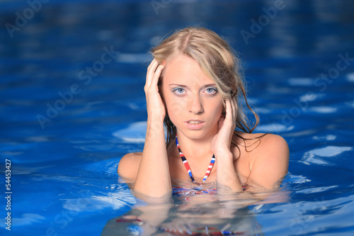 Beautiful woman posing in pool