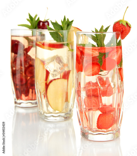 Glasses of fruit drinks with ice cubes isolated on white