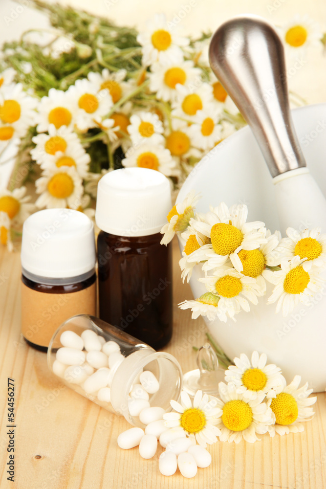 Medicine chamomile flowers on wooden table Medicine chamomile flowers on wooden table