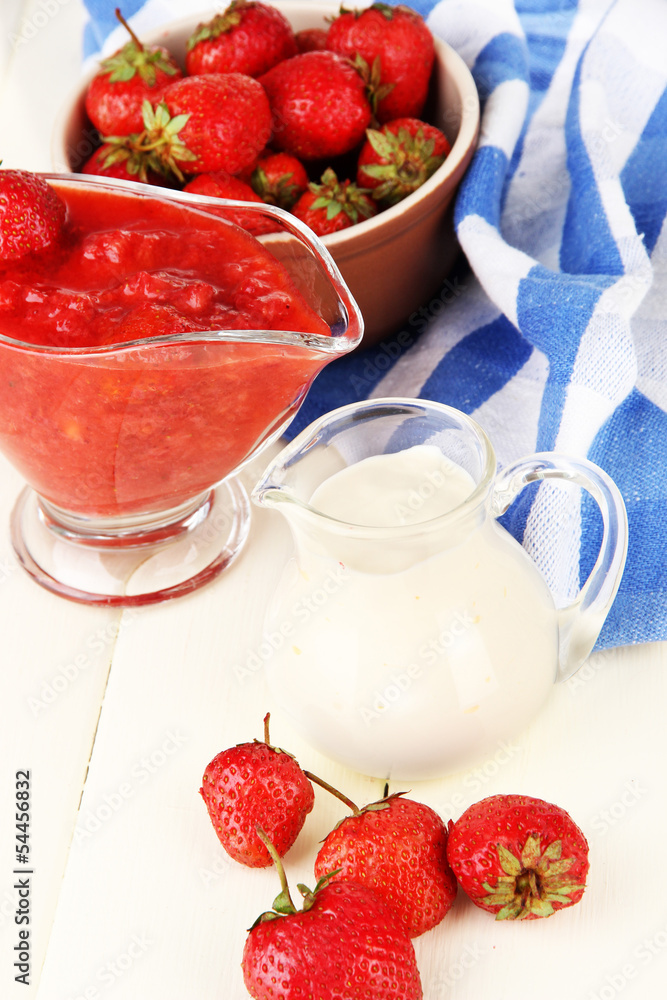 Homemade strawberry jam, on napkin, on color wooden background Homemade strawberry jam, on napkin, on color wooden background