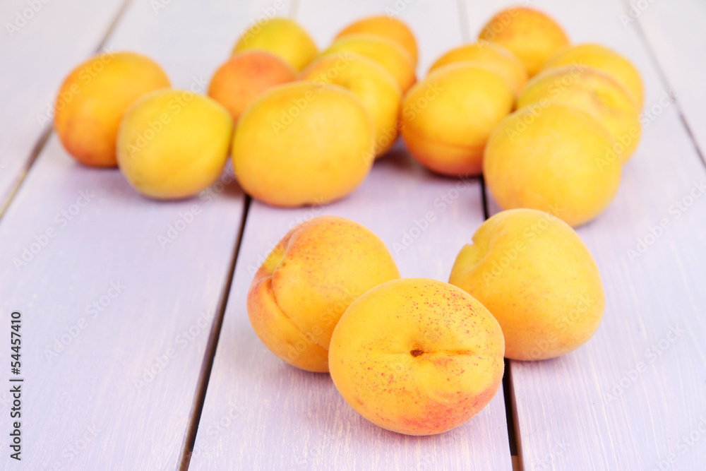 Fresh natural apricot on wooden table close up