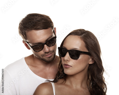 Couple wearing sunglasses isolated over a white background