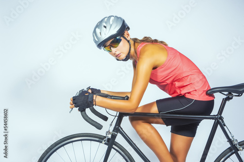 Fototapeta Naklejka Na Ścianę i Meble -  young female professional cycling athlete posing with racing bik