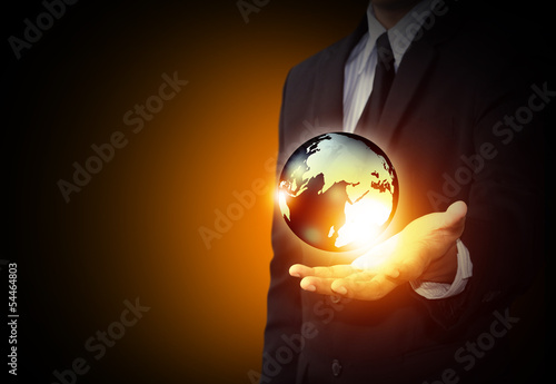 Fototapeta Naklejka Na Ścianę i Meble -  Holding a glowing earth globe in hand