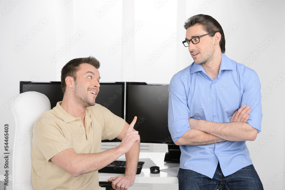 He has another point of view. Two young businessmen talking abou He has another point of view. Two young businessmen talking abou