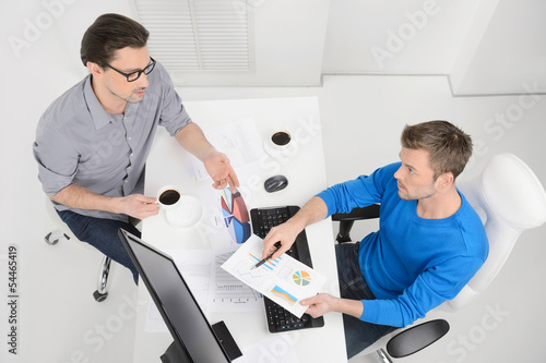 Business planning. Top view of two businessmen dicussing somethi