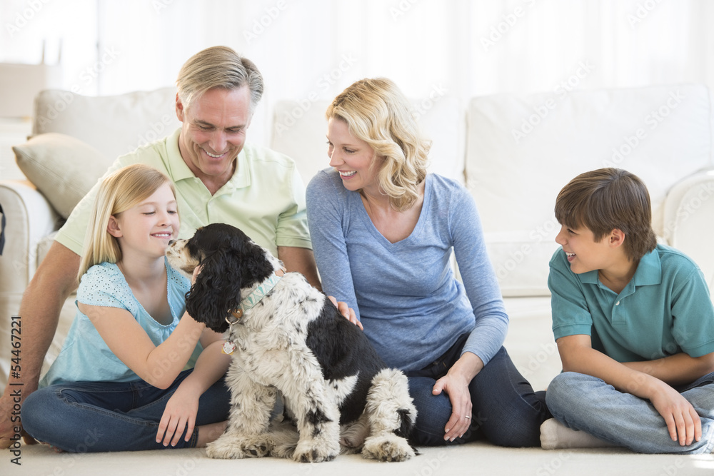Happy Girl Playing With Dog While Family Looking At Her Happy Girl Playing With Dog While Family Looking At Her