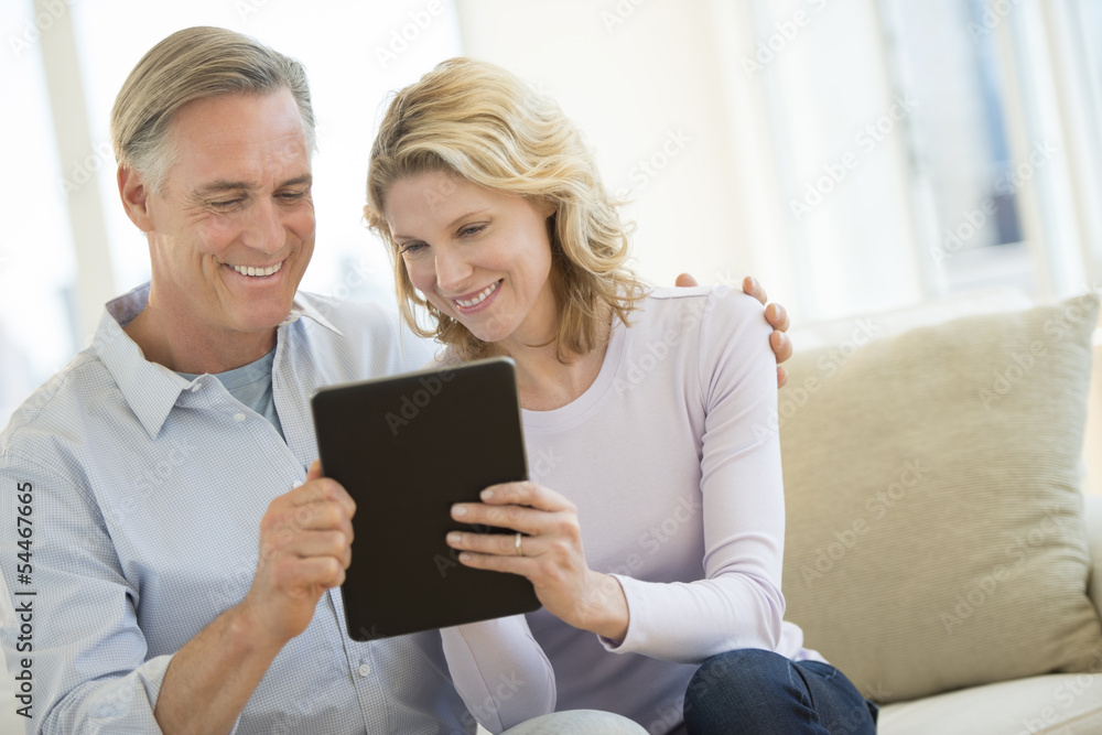 Couple Using Digital Tablet At Home Couple Using Digital Tablet At Home
