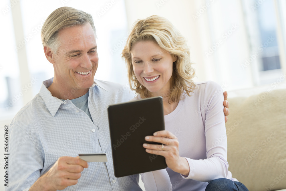 Couple With Credit Card And Digital Tablet Shopping Online