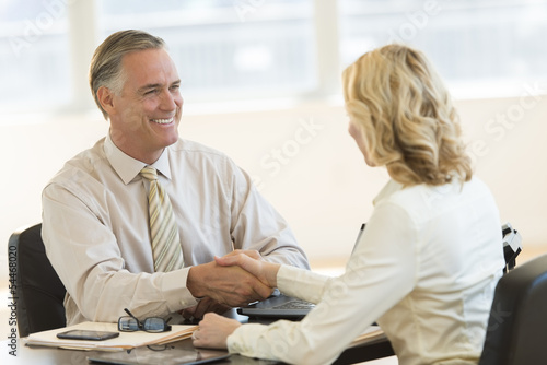 Wallpaper Mural Businessman Shaking Hands With Colleague At Desk Torontodigital.ca