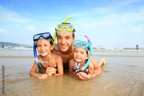 Portrait of father and children wearing diving mask
