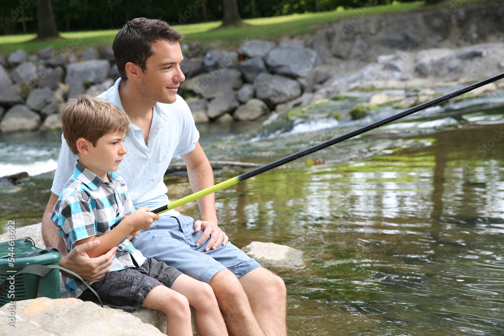 Father teaching son how to fish in river Father teaching son how to fish in river