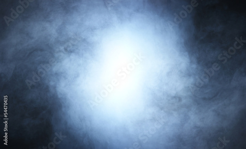 A beautiful blue smoke background with light in the center