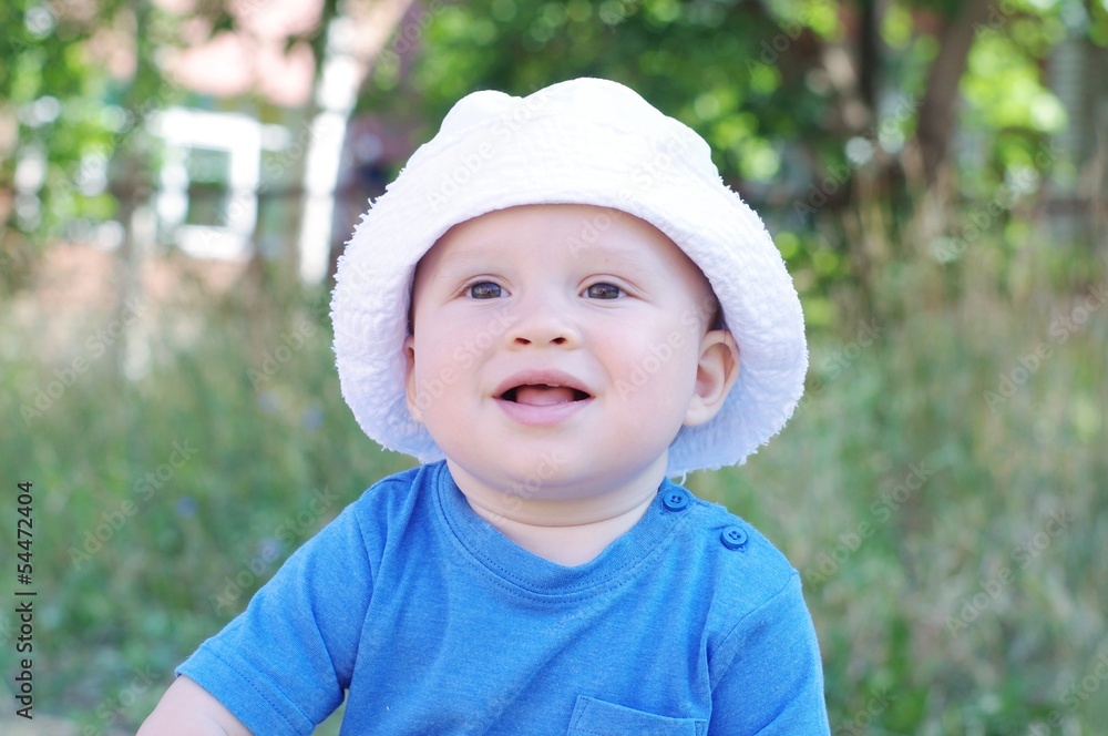 portrait of smiling baby in white hat portrait of smiling baby in white hat
