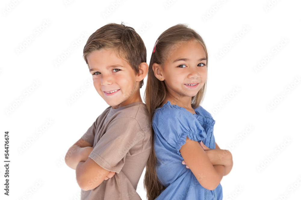 Children standing back to back with arms crossed Children standing back to back with arms crossed