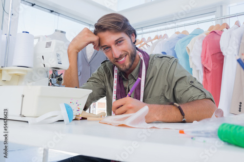 Happy designer working at his desk