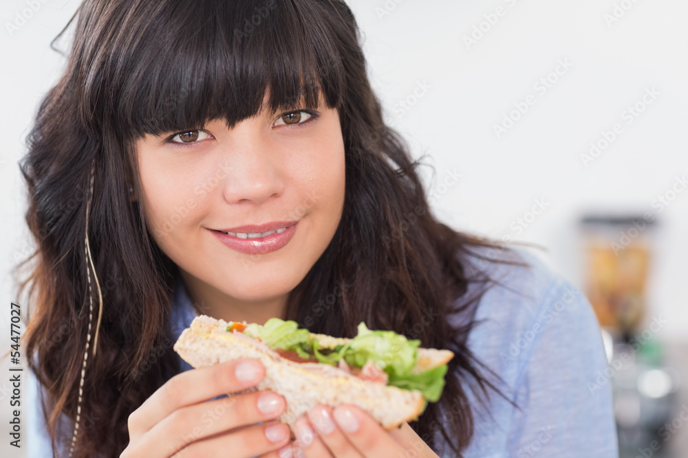 Happy brunette having a salad sandwich Happy brunette having a salad sandwich