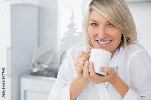 Happy woman having coffee in the morning