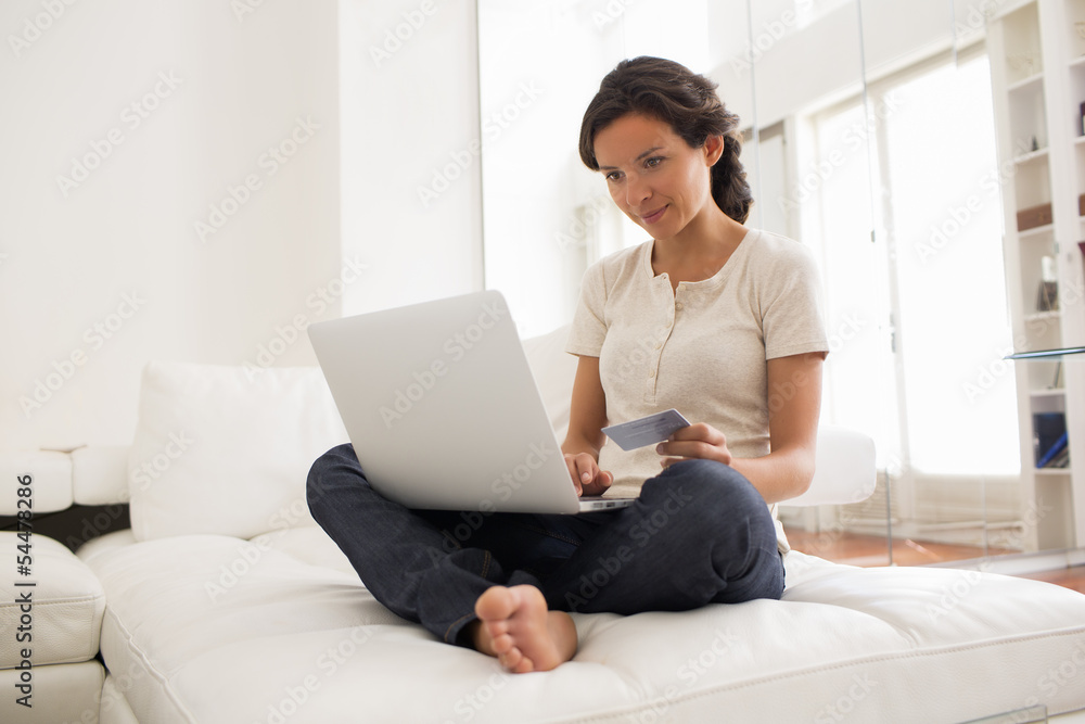 Young pretty woman shopping using laptop at home Young pretty woman shopping using laptop at home